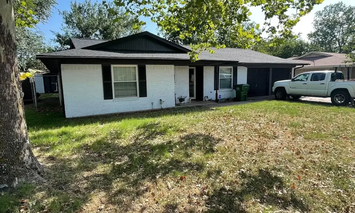Professional roofing crew working on a residential roof in Janesville